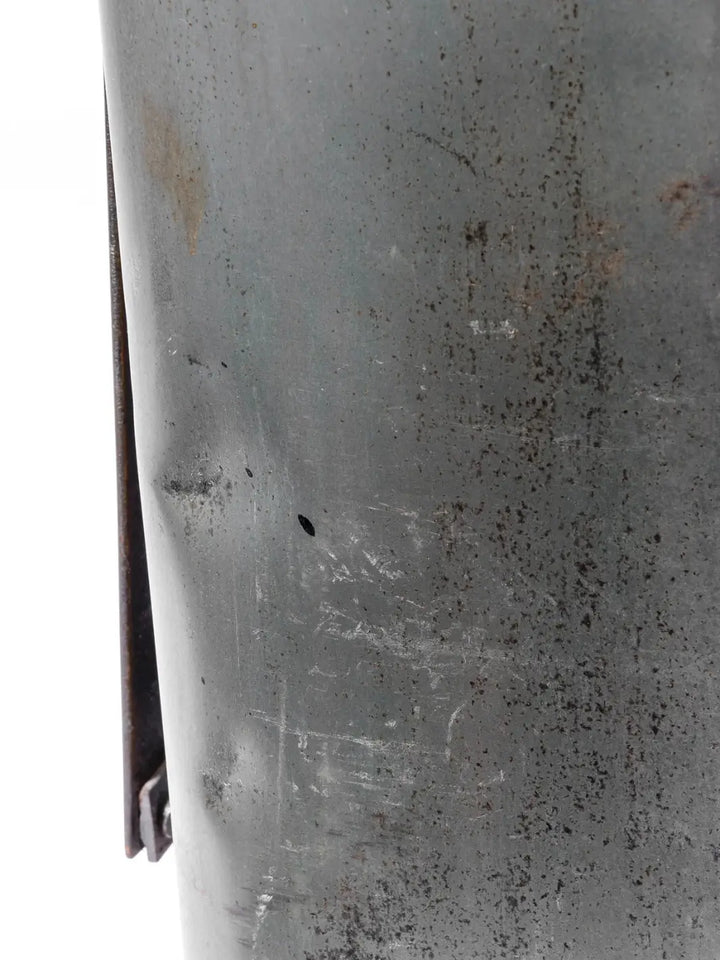 Top-down perspective shot captures the embossed "TRASH ONLY" lettering and a safety warning stamped onto the weathered metal surface of the Step Trash Can - Natural from Puebco | Twentyseven Toronto