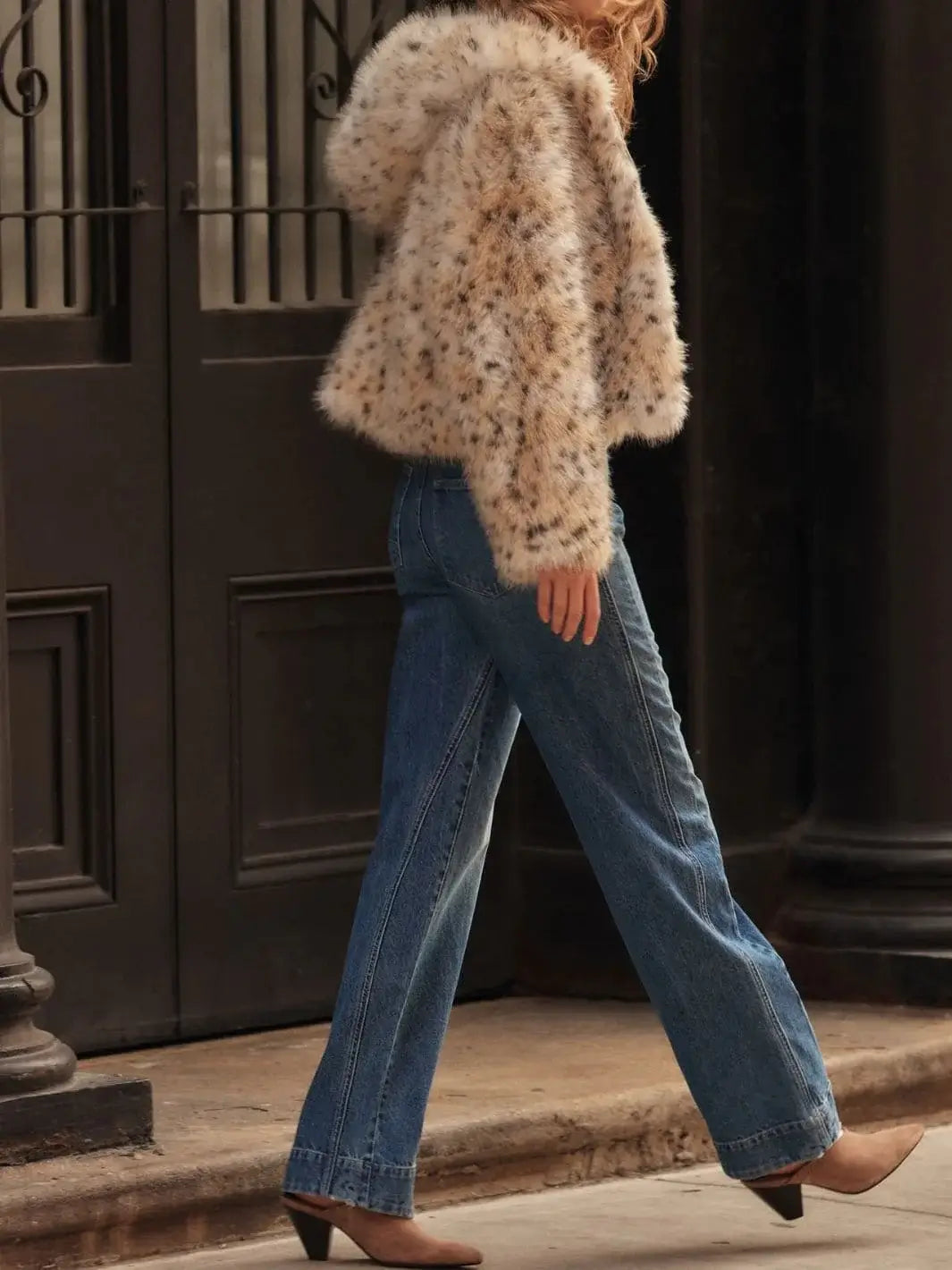 A side profile view captures a model walking outdoors, showing the clean hem and structured drape of the Free People Stick Around Slim Curve Jeans - Stay For The Morning | Twentyseven Toronto