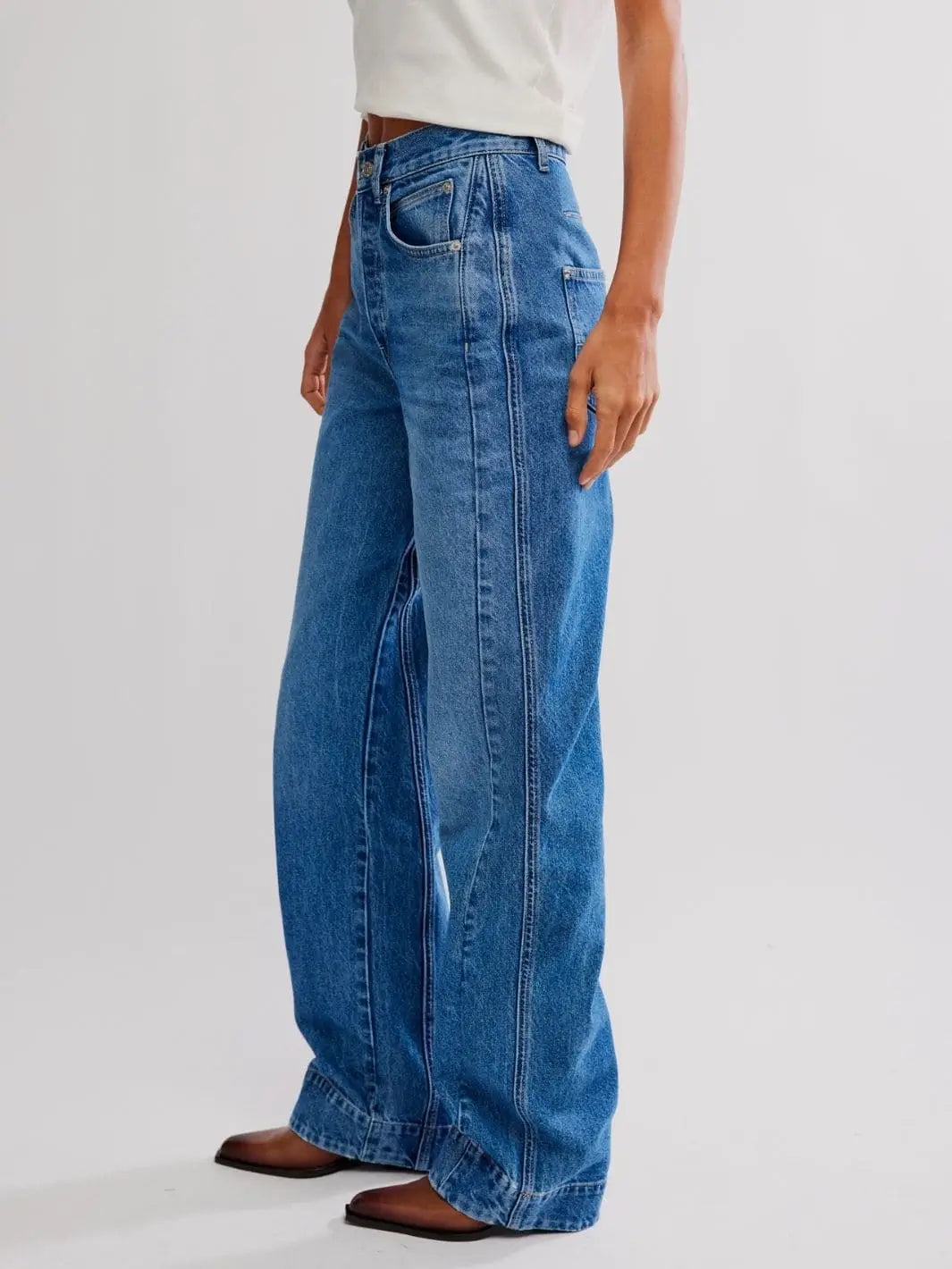 A side profile view highlights the unique outer seam line and relaxed fit of the Free People Stick Around Slim Curve Jeans - Stay For The Morning | Twentyseven Toronto