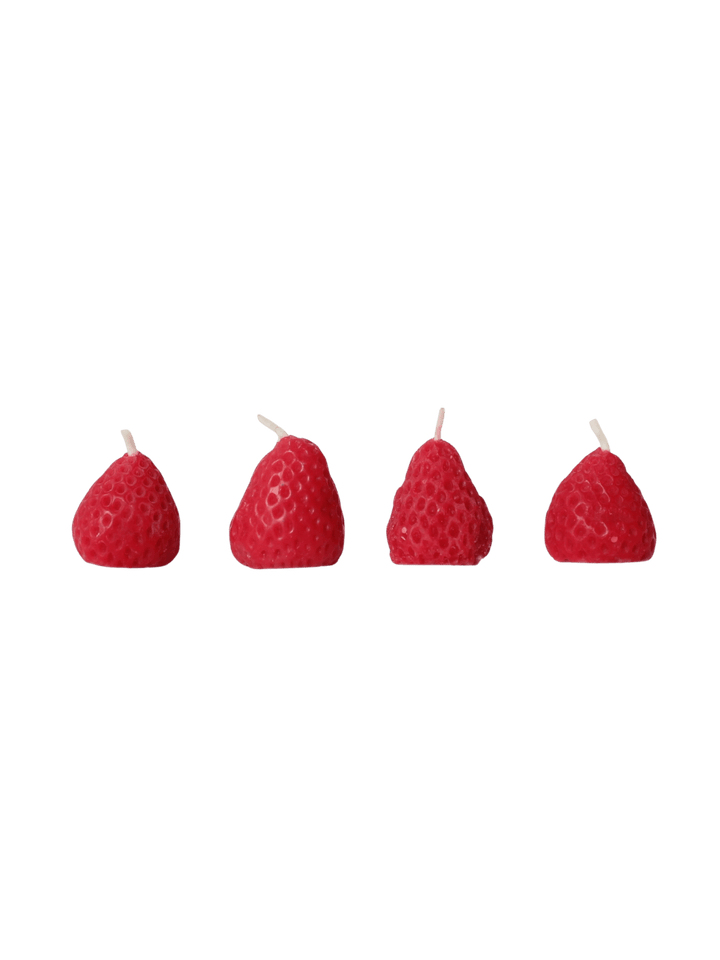 Four red strawberry-shaped beeswax candles from Happy Organics on a transparent background | Twentyseven Toronto