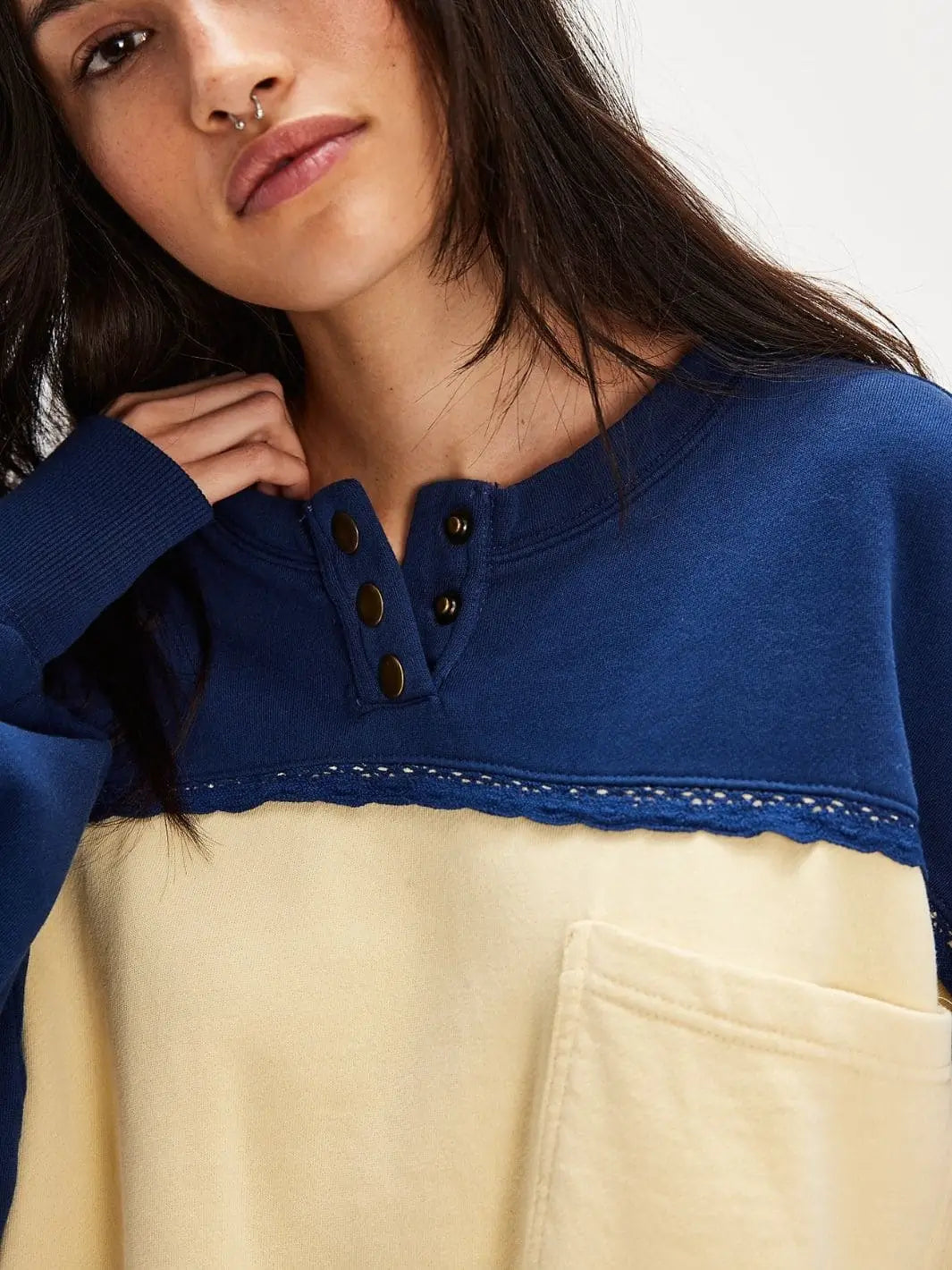 A close-up front view focuses on the split henley neckline, bronze button hardware, and intricate lace detailing of the Free People Strawberry Sweatshirt - Oceana Combo | Twentyseven Toronto