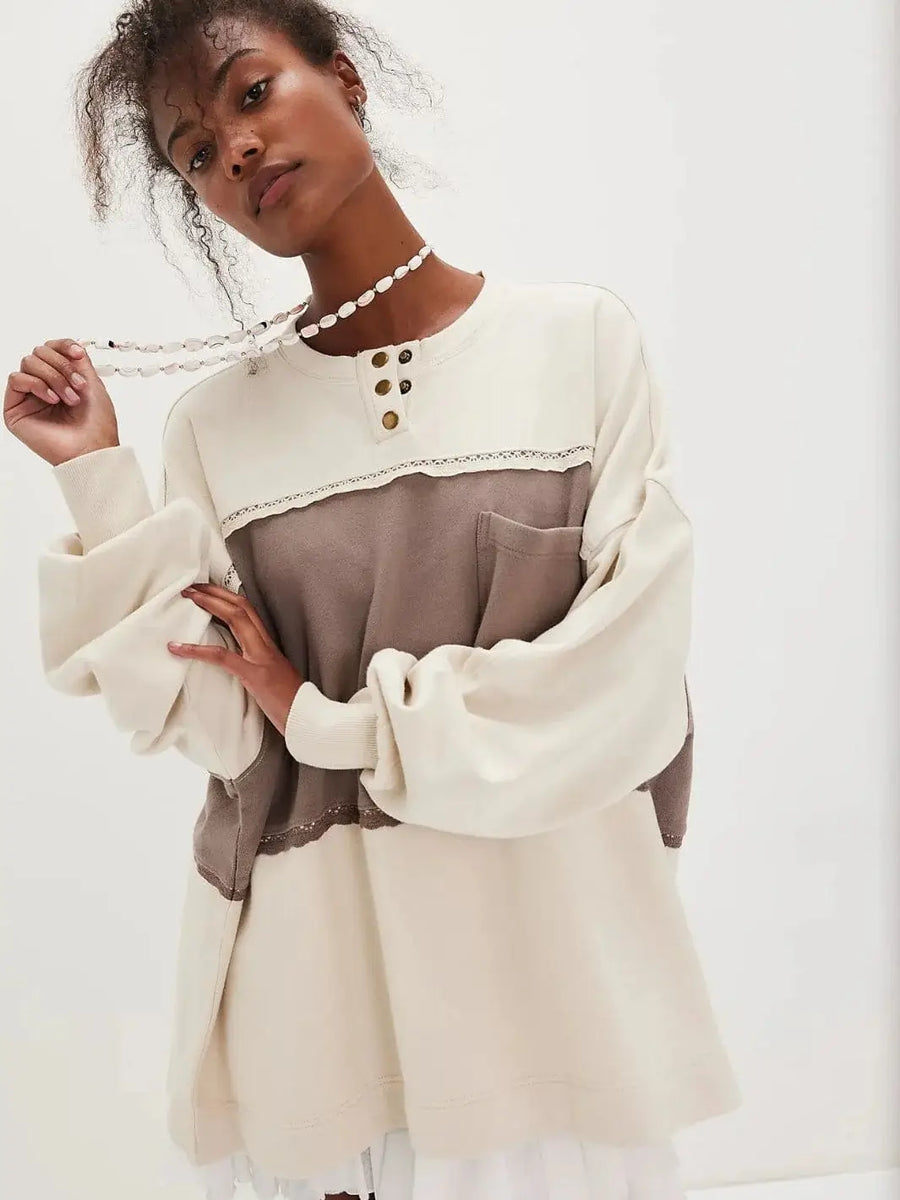 Front view of a model showcasing the relaxed, oversized fit and slouchy sleeves of the Free People Strawberry Sweatshirt - Summer Sand Combo | Twentyseven Toronto