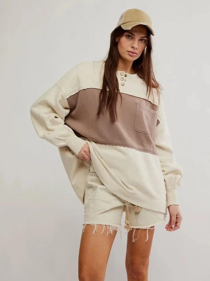 A model poses in the Free People Strawberry Sweatshirt - Summer Sand Combo styled with matching denim shorts and a distressed baseball cap | Twentyseven Toronto