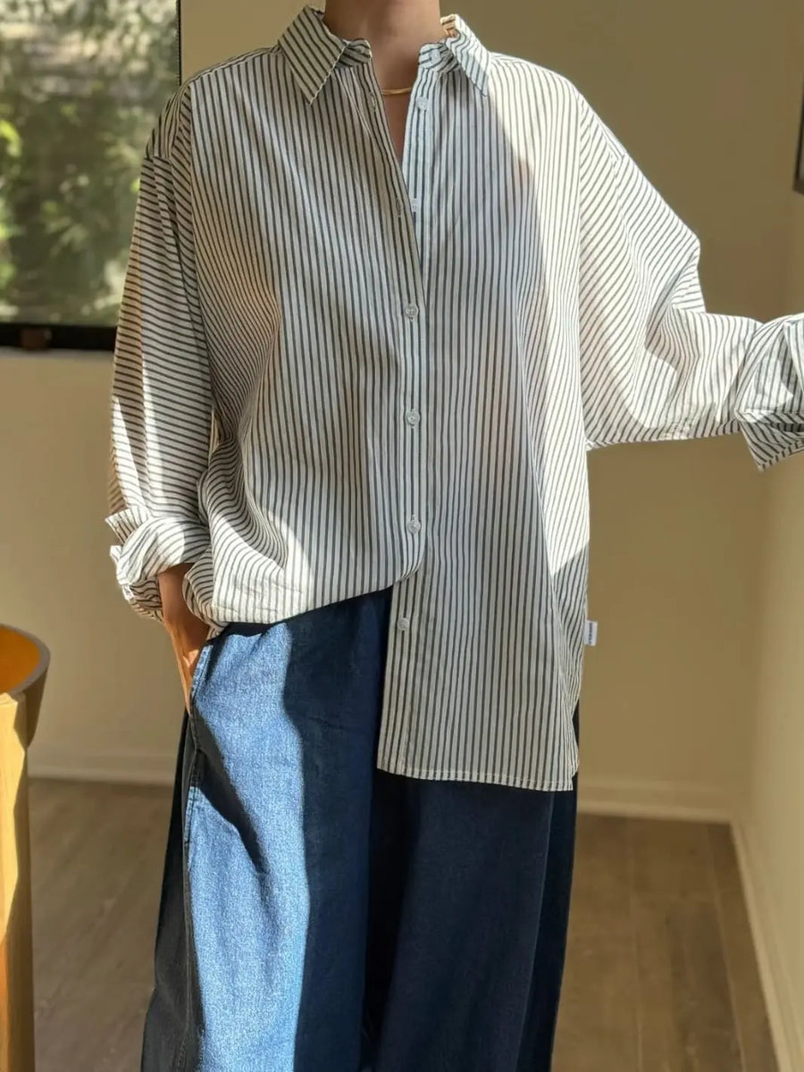 Person wearing a Striped 'Light Weight Owen Shirt' in 'Denim Stripe On White' and blue pants from Le Bon Shoppe in an indoor setting | Twentyseven Toronto
