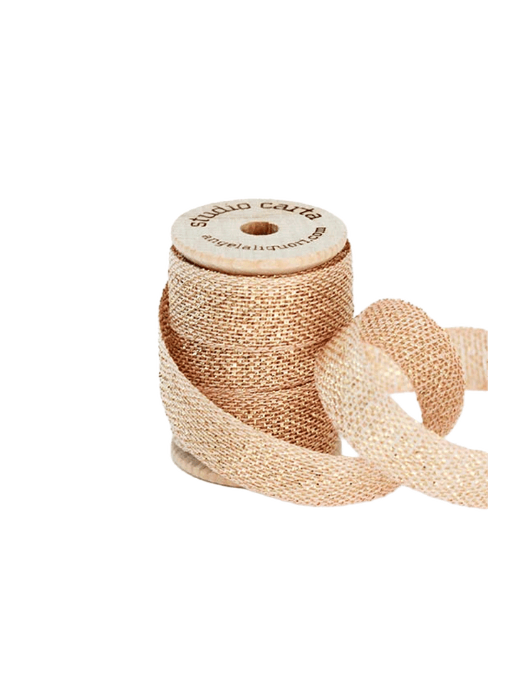 Studio Carta Metallic Loose Weave Ribbon in Blush/Gold wrapped around a wooden spool with ribbon unfurled | Twentyseven Toronto