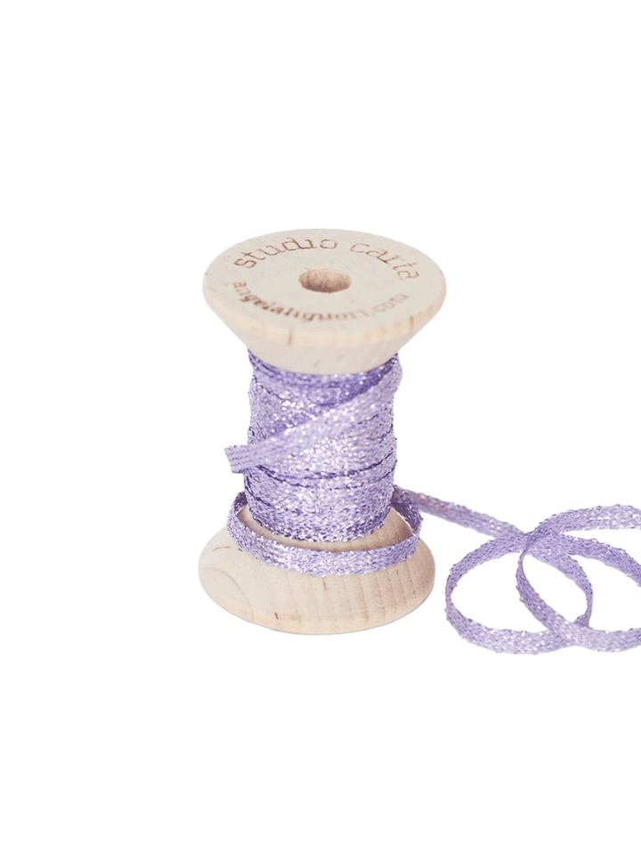 Studio Carta Metallic Braided Ribbon in Lilac wrapped around a wooden spool with ribbon unfurled | Twentyseven Toronto