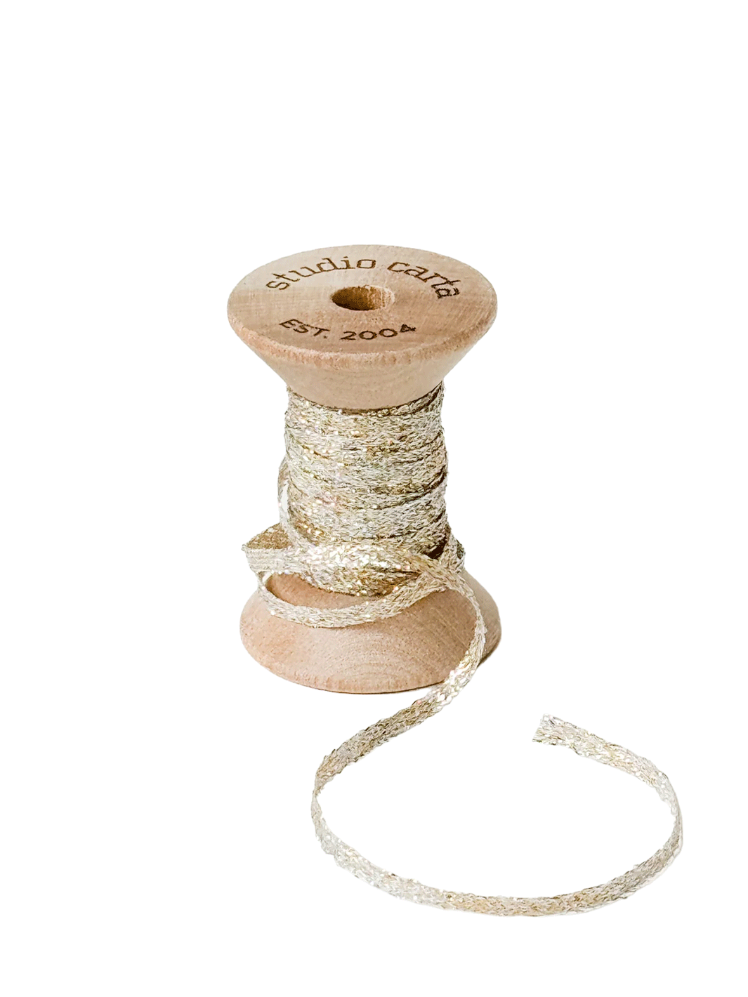 Studio Carta Metallic Braided Ribbon in Pearl wrapped around a wooden spool with ribbon unfurled | Twentyseven Toronto