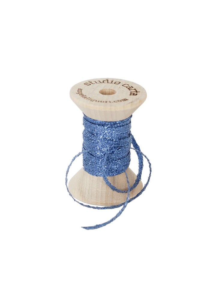Studio Carta Metallic Braided Ribbon in Wave wrapped around a wooden spool with ribbon unfurled | Twentyseven Toronto