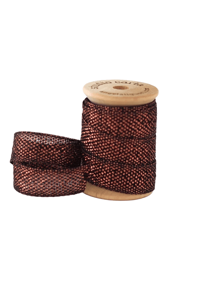 Studio Carta Metallic Loose Weave Ribbon in Black/Copper wrapped around a wooden spool with ribbon unfurled | Twentyseven Toronto