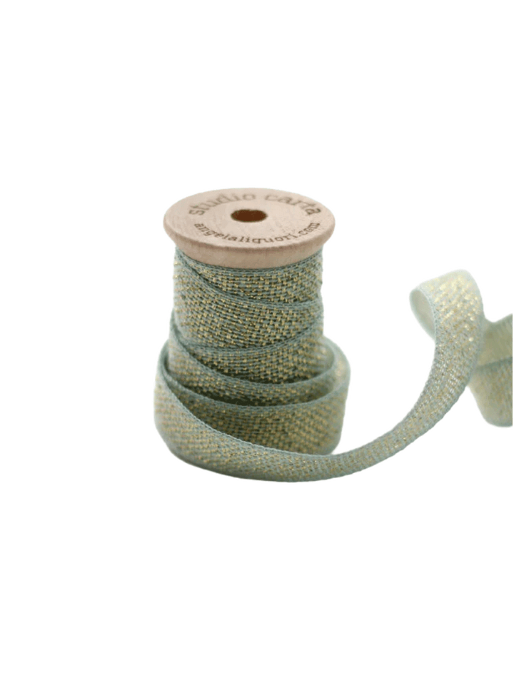 Studio Carta Metallic Loose Weave Ribbon in Pool/Gold wrapped around a wooden spool with ribbon unfurled | Twentyseven Toronto