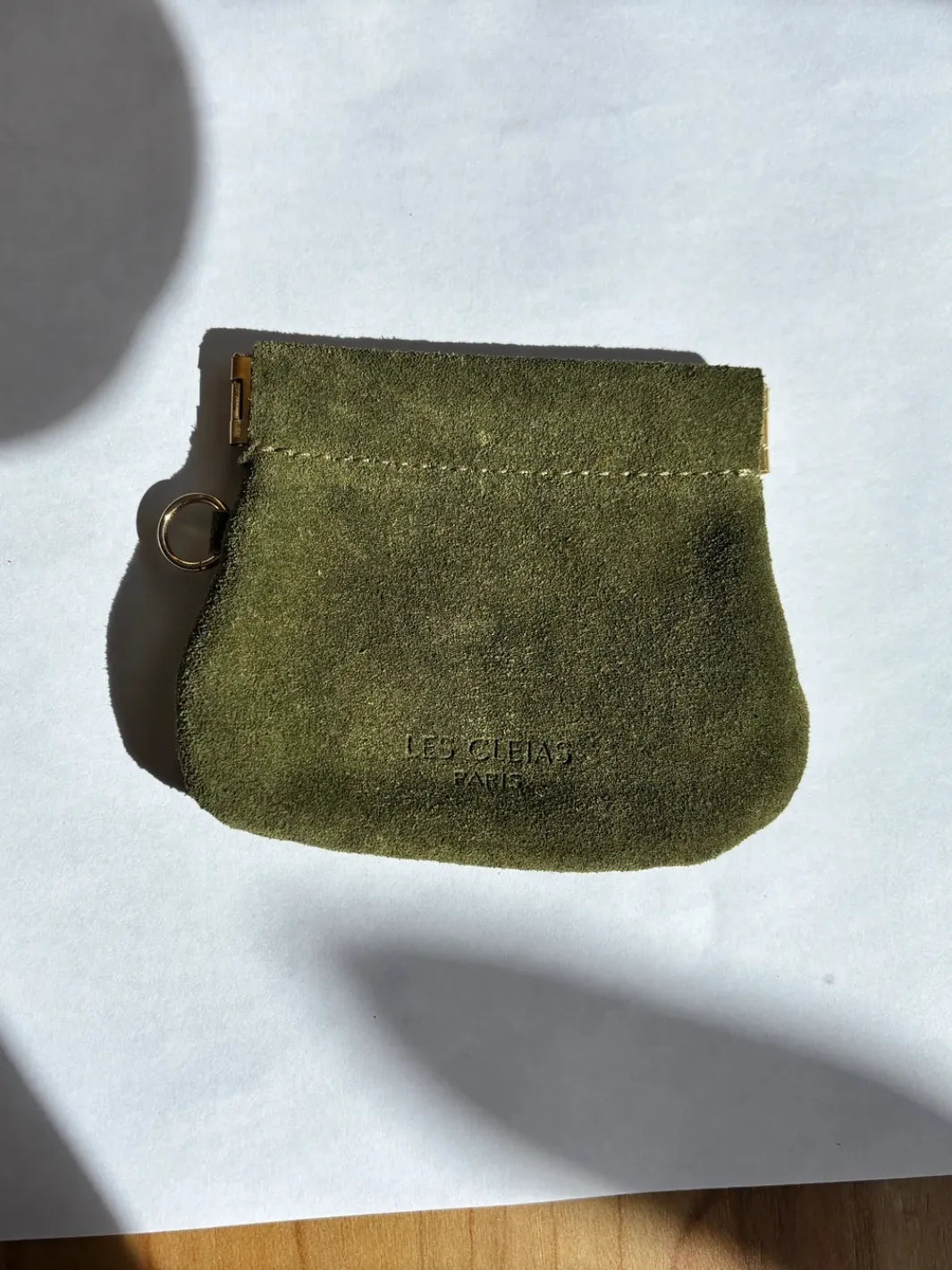 Dark green suede coin pouch in 'Forest Green' with gold holder on a white background | Twentyseven Toronto