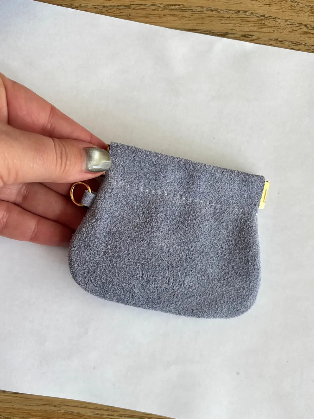 Hand holding a small light purple coin pouch in 'Periwinkle' against a white background | Twentyseven Toronto