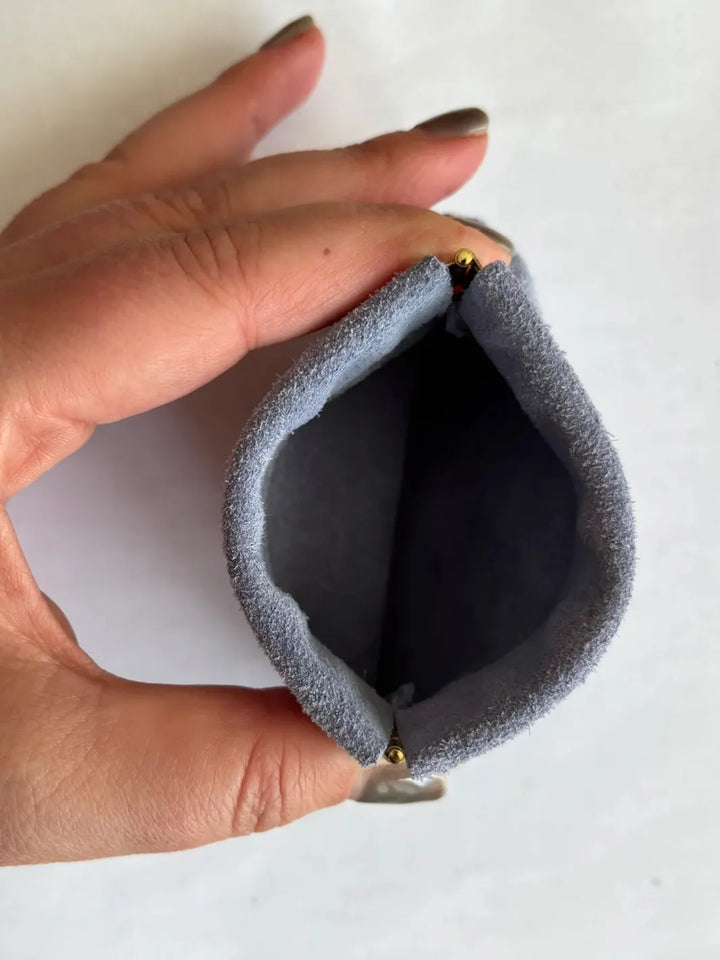Hand holding a small light purple coin pouch in 'Periwinkle' against a white background | Twentyseven Toronto