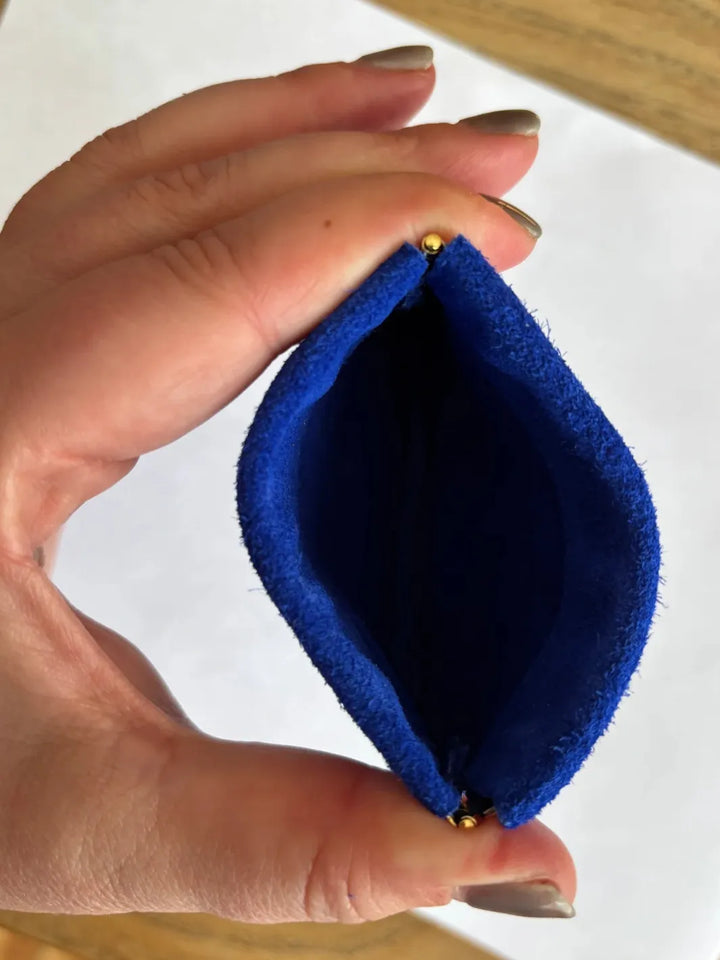 Hand holding a dark blue coin pouch in 'Royal Blue' against a white background | Twentyseven Toronto