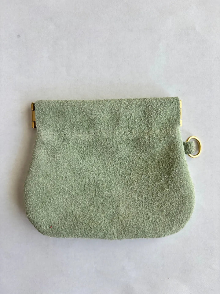 Sage green textured suede coin pouch with gold holder on a white background | Twentyseven Toronto