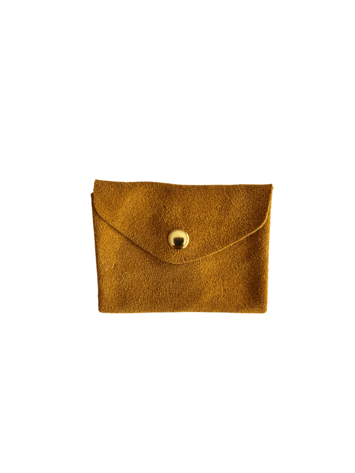 Dark yellow suede coin purse in 'Mustard' with a gold button on a transparent background | Twentyseven Toronto