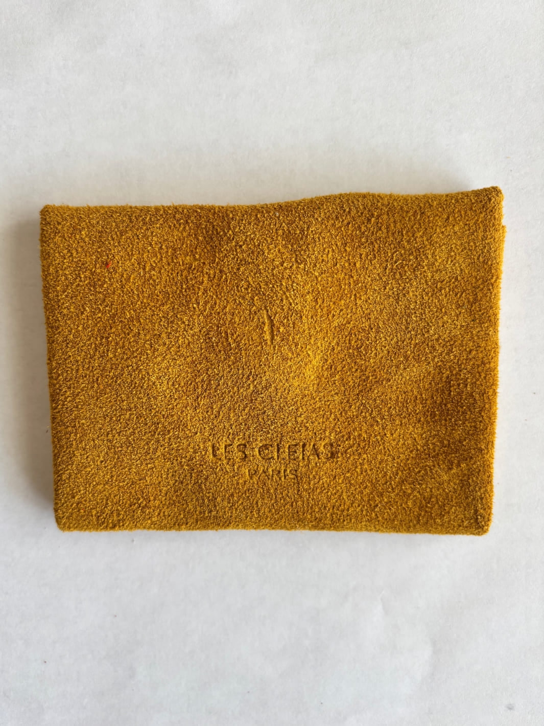 Dark yellow suede coin purse in 'Mustard' with branding 'Les Cleias Paris', back view | Twentyseven Toronto