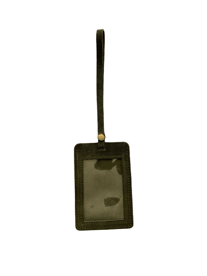 Dark green suede luggage tag in 'Forest Green' with gold clasp on a transparent background | Twentyseven Toronto