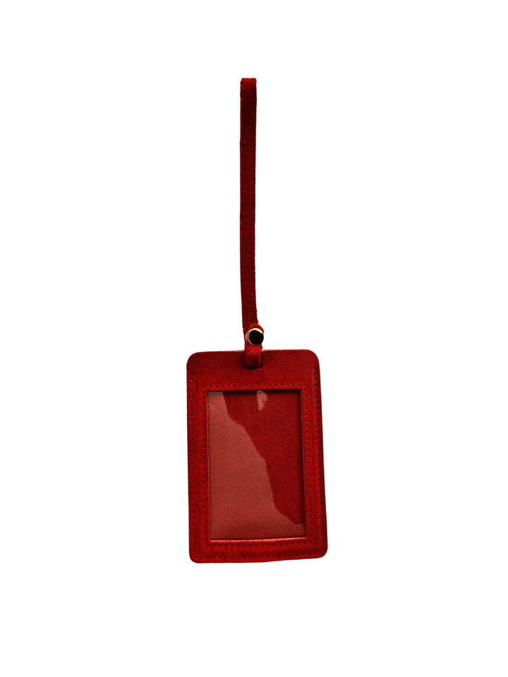 Red suede luggage tag with gold clasp on a transparent background | Twentyseven Toronto