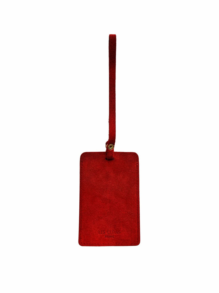 Red suede luggage tag with gold clasp on a white background, back view | Twentyseven Toronto