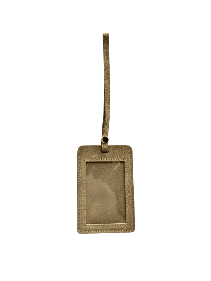 Light brown suede luggage tag in 'Taupe' with gold clasp on a transparent background | Twentyseven Toronto