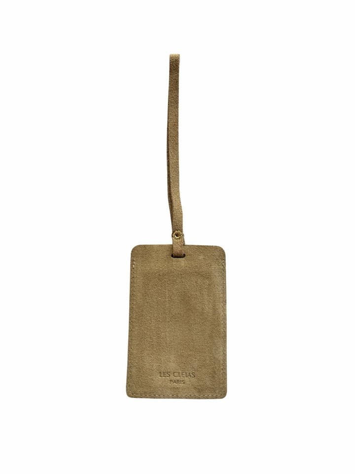 Light brown suede luggage tag in 'Taupe' with gold clasp on a white background, back view | Twentyseven Toronto