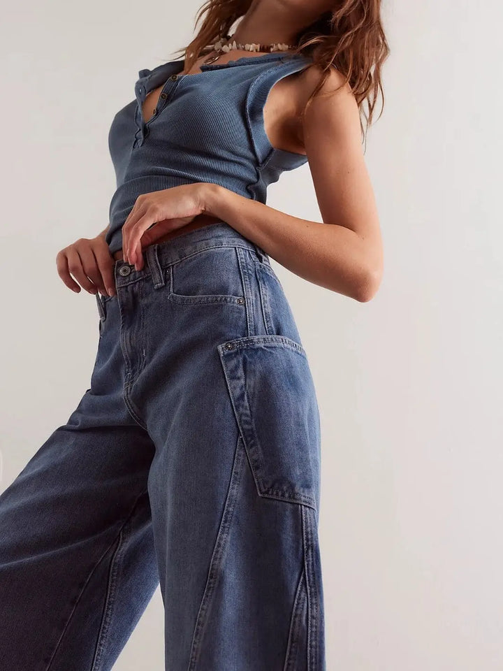 A close-up side angle showcases the mid-rise waist, pocket placement, and structured paneling of the Free People Sugar And Spice Barrel Jeans - Beatrix Indigo | Twentyseven Toronto