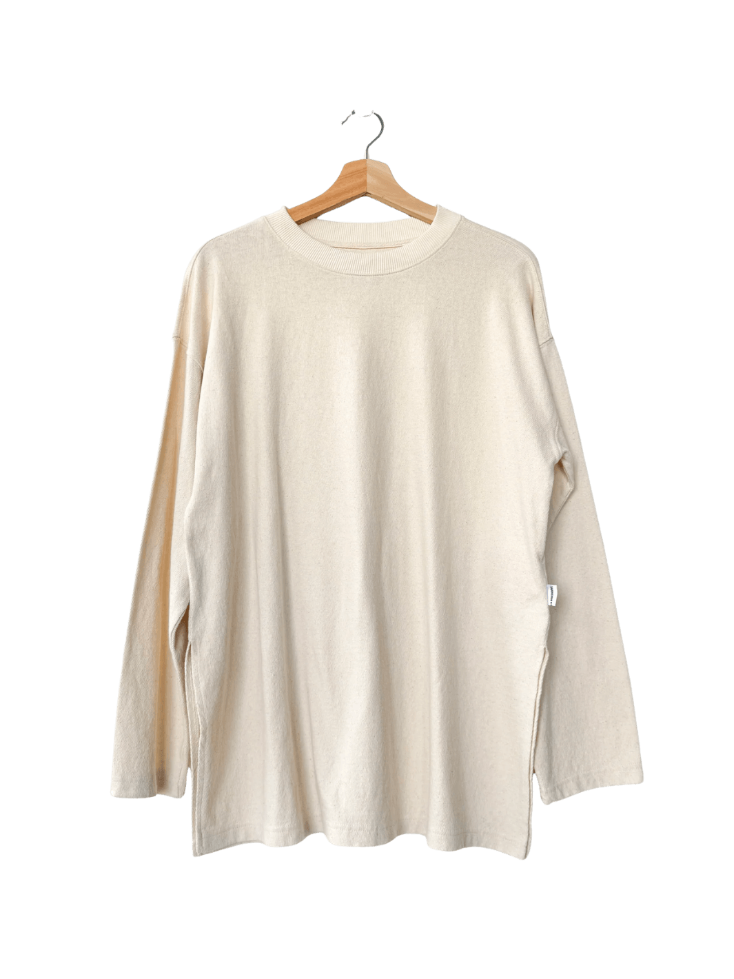 Off-white long-sleeve 'Sunday Tee' shirt in 'Naturel' on a hanger against a transparent background | Twentyseven Toronto