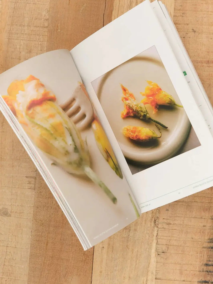 An open page spread of the Flamingo Estate Sunny Side Up Recipe Book showcasing images of stuffed squash blossoms | Twentyseven