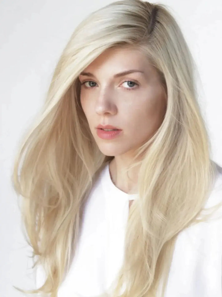 A model with long, bright blonde hair after using R+Co SUNSET BLVD Blonde Shampoo | Twentyseven Toronto