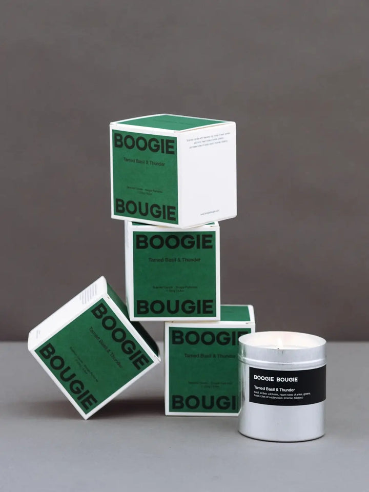 Boogie Bougie green product packaging and silver Tamed Basil and Thunder candle container on a gray background | Twentyseven Toronto