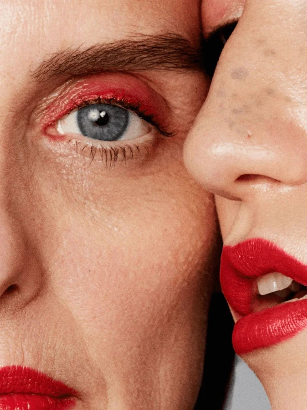 Close-up shot of a 2 women's face with red eye makeup and red lipstick from 19/99 Beauty | Twentyseven Toronto
