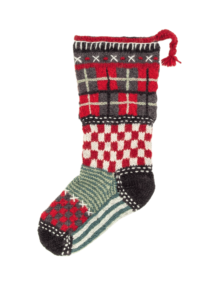 Lost Horizons Canada Tartan Knit Christmas Stocking featuring a hand-knit patchwork of red, black, cream and green plaid and gingham patterns with a braided hanging loop | Twentyseven Toronto