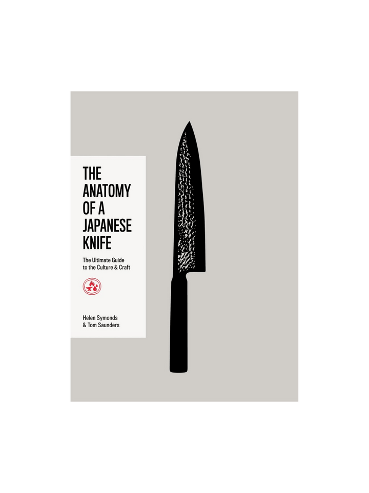 Front cover of The Anatomy of a Japanese Knife by Helen Symonds and Tom Saunders, featuring a large, textured black knife silhouette centered on a grey background, with a white title block on the left side including the subtitle "The Ultimate Guide to the Culture & Craft." | Twentyseven Toronto