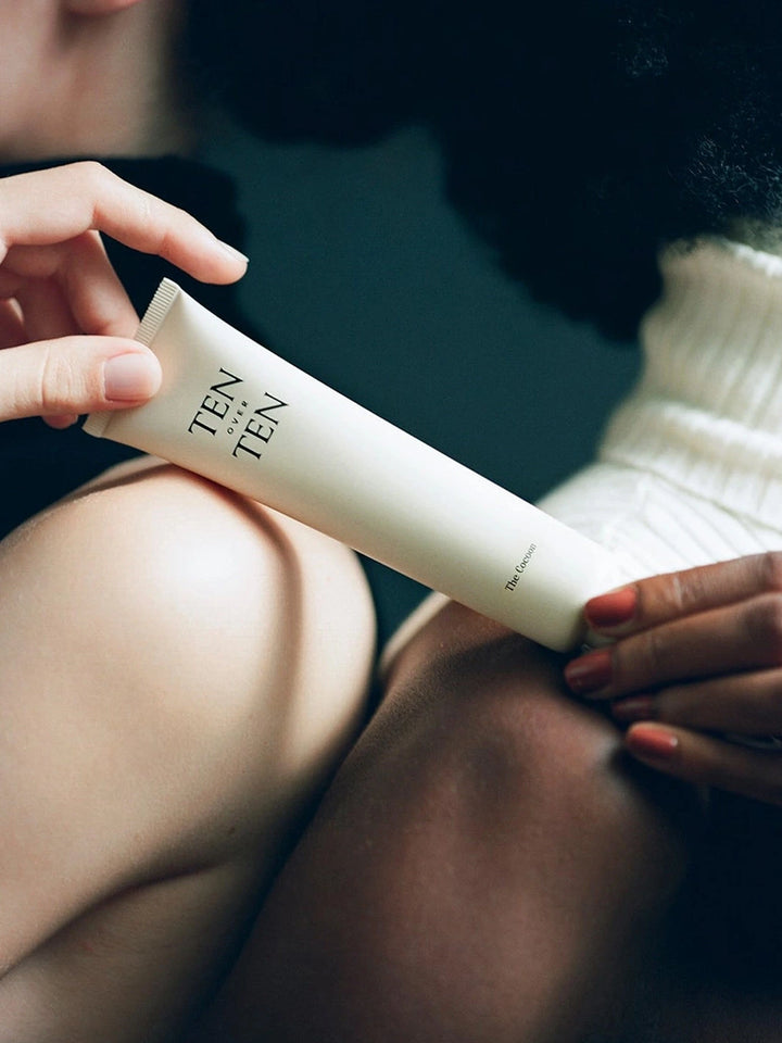 TENOVERTEN The Cocoon Hand + Foot Cream held in hand for a lifestyle product shot | Twentyseven Toronto