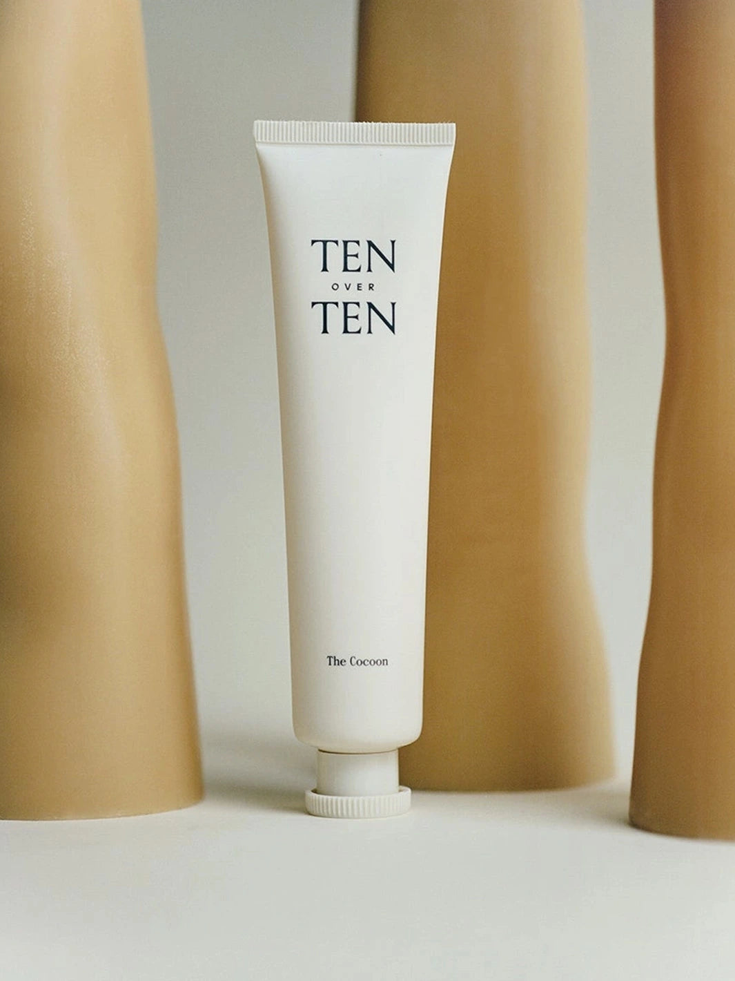 TENOVERTEN The Cocoon Hand + Foot Cream tube displayed against a warm neutral backdrop | Twentyseven Toronto
