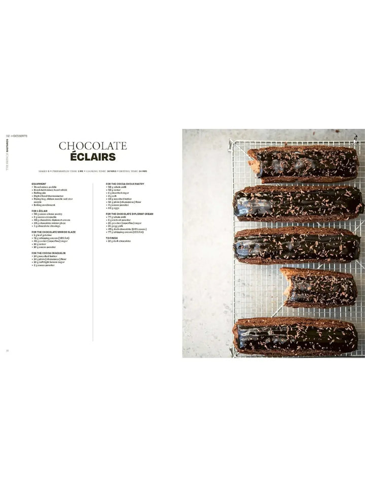 Five long chocolate éclairs with a glossy dark chocolate glaze and cocoa nib sprinkles, resting on a wire cooling rack from The French Bastards cookbook | Twentyseven Toronto