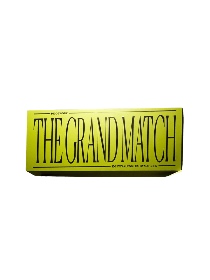 A vibrant green rectangular box containing The Grand Match from Piecework Puzzles against a transparent background | Twentyseven Toronto