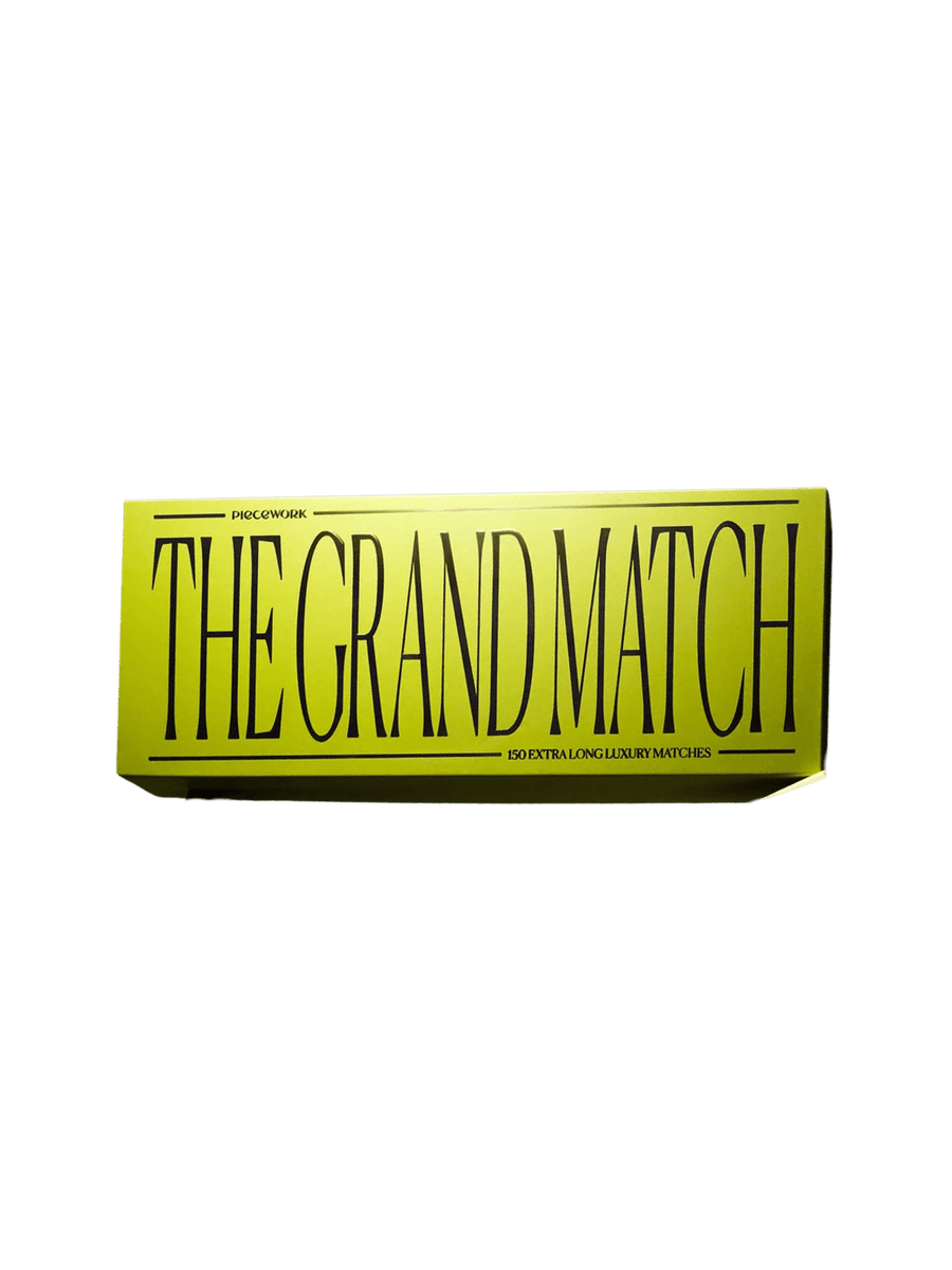 A vibrant green rectangular box containing The Grand Match from Piecework Puzzles against a transparent background | Twentyseven Toronto