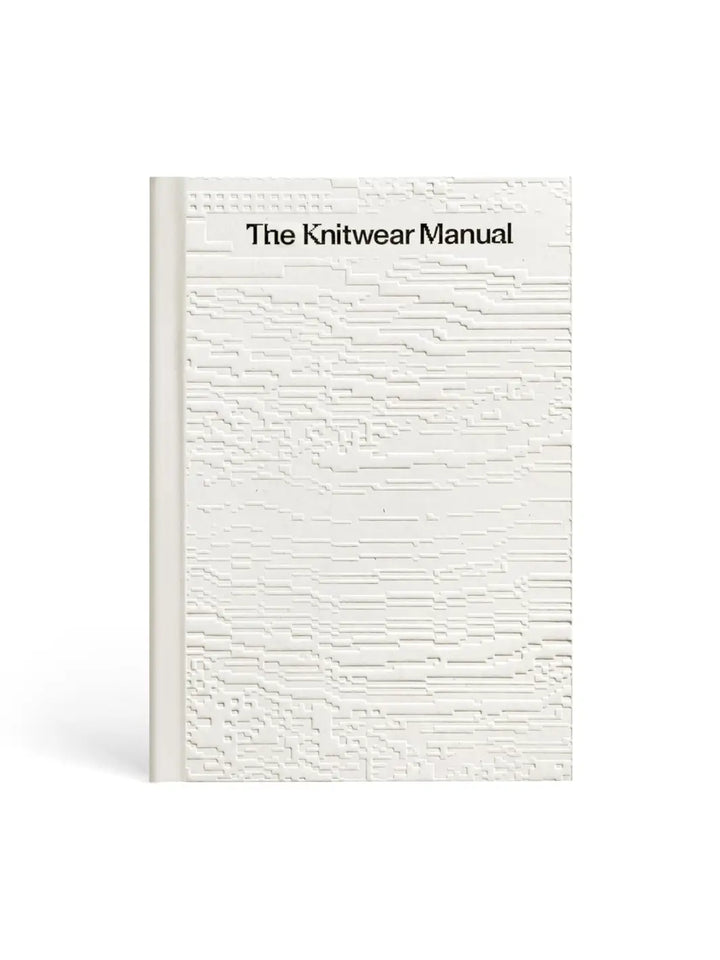 Front-facing view of the cover of The Knitwear Manual: A Complete Guide to Knitwear Design by Fashionary, highlighting debossed patterns | Twentyseven Toronto