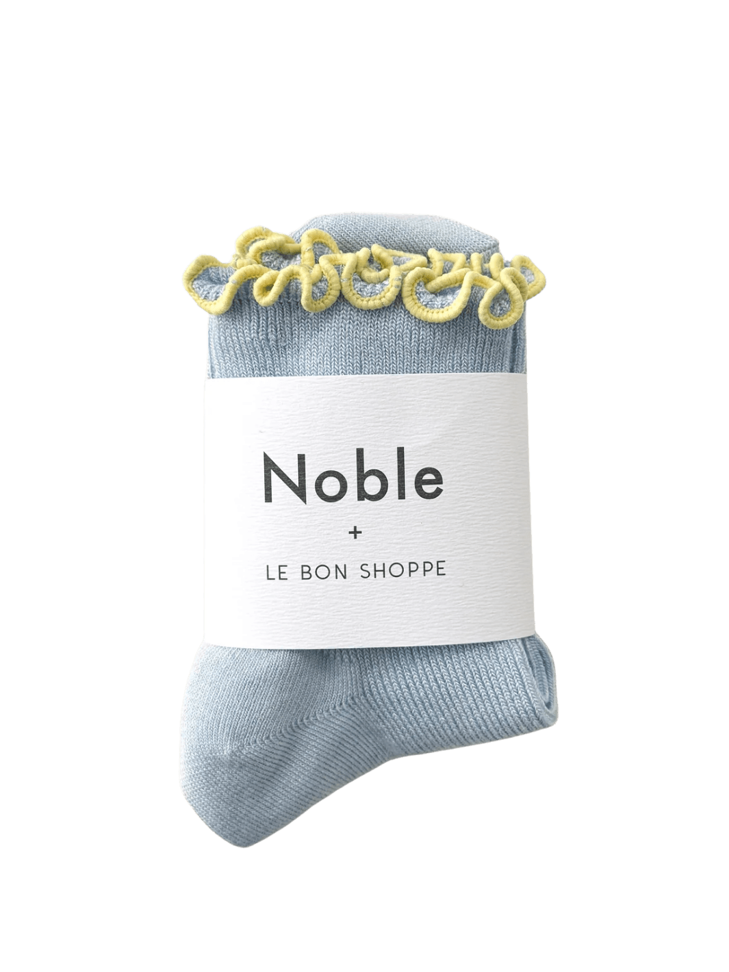 A pair of Petite Ruffled Modal Socks in Baby Blue / Butter from Le Bon Shoppe is displayed with its white "Noble + LE BON SHOPPE" collaborative packaging band | Twentyseven Toronto