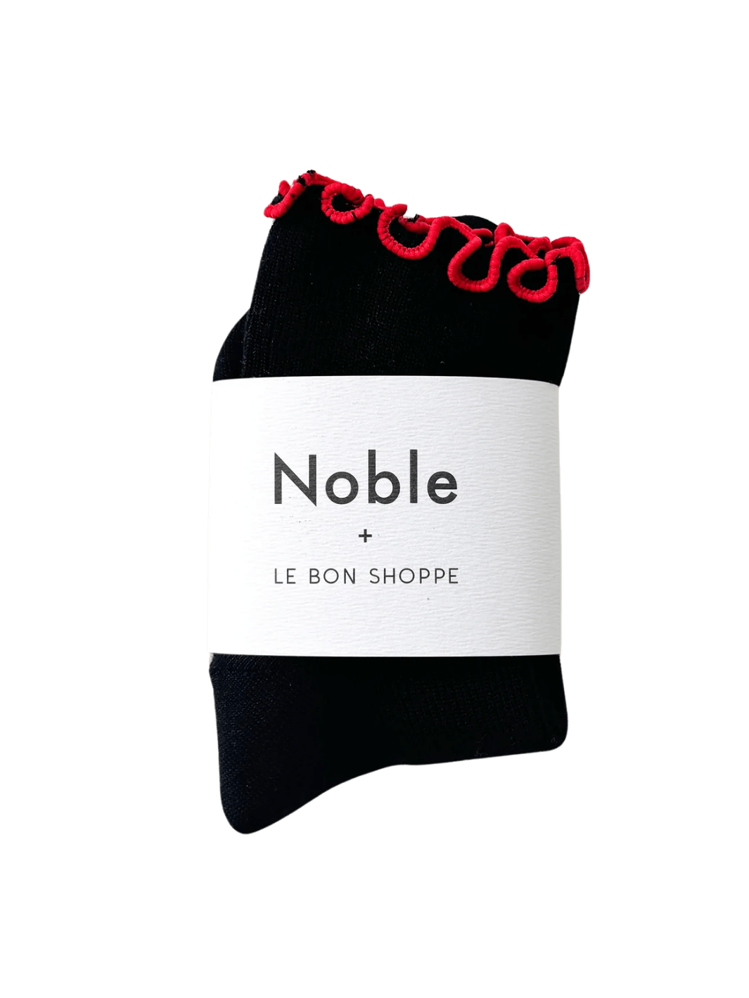 A pair of The Petite Ruffled Modal Socks in Black / Red from Le Bon Shoppe is beautifully displayed with its white "Noble + LE BON SHOPPE" collaborative packaging band | Twentyseven Toronto