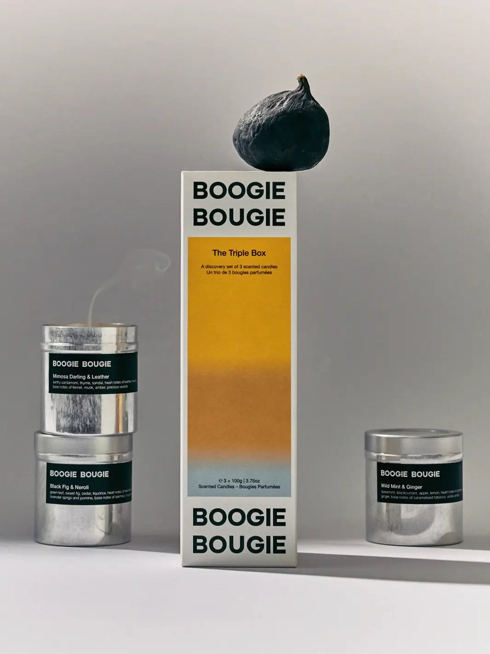 Set of three 'The Triple Box While summer Shifts' Boogie Bougie candles and packaging on a neutral background | Twentyseven Toronto