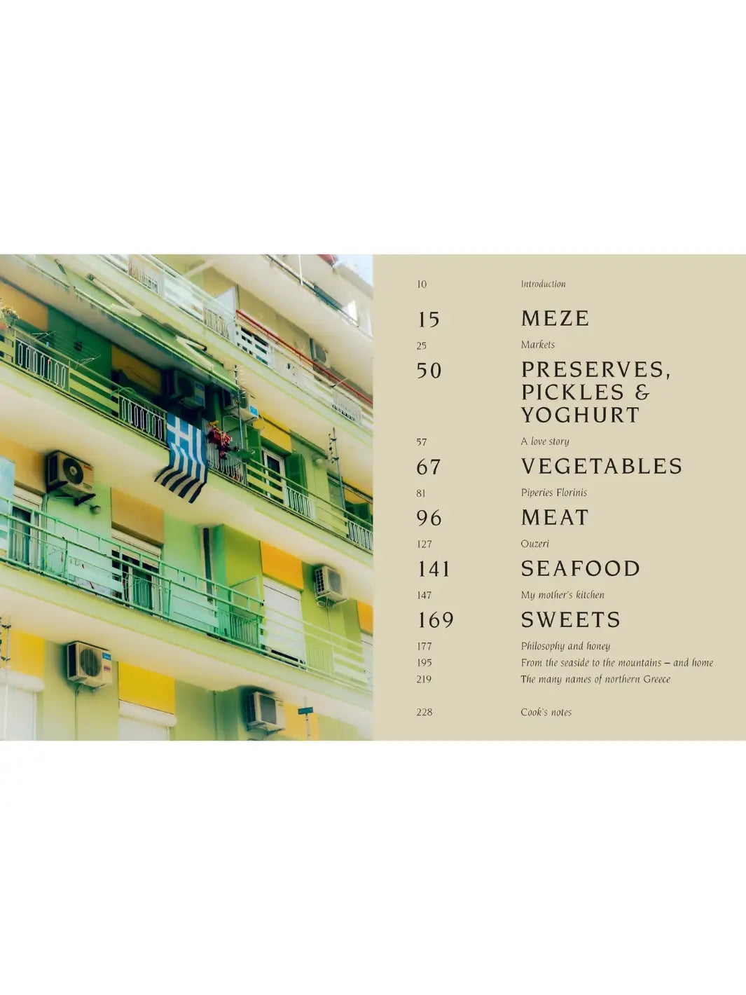 Table of contents spread from Thessaloniki: And the Many Kitchens of Northern Greece by Meni Valle featuring a full-page photograph of a green apartment building with a Greek flag hanging from a balcony and the chapter list beside it | Twentyseven Toronto