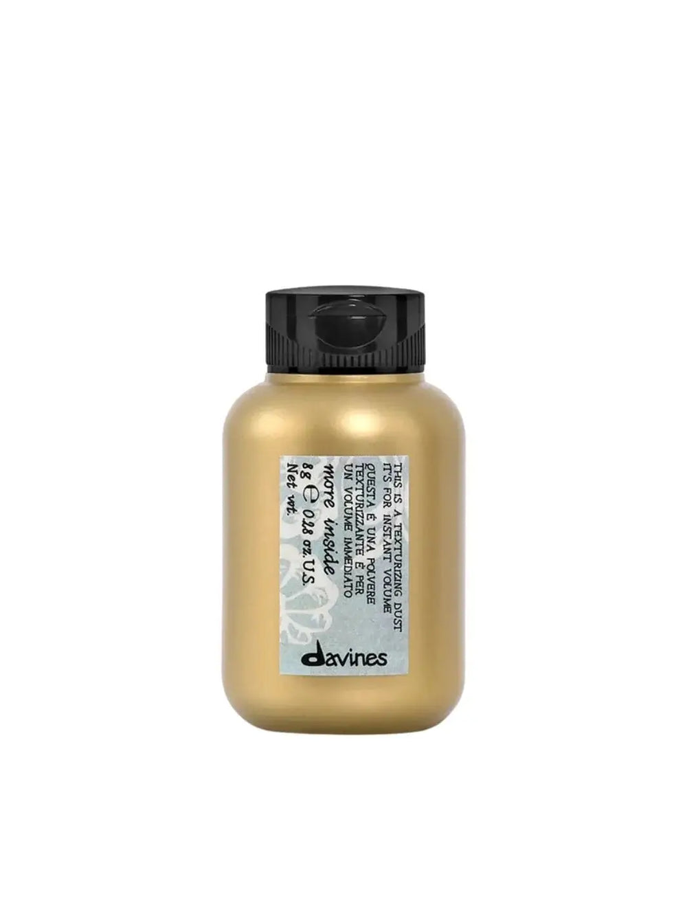 A small, gold plastic bottle of Davines This is a Texturizing Dust with a grey patterned label is centered against a solid white background | Twentyseven Toronto