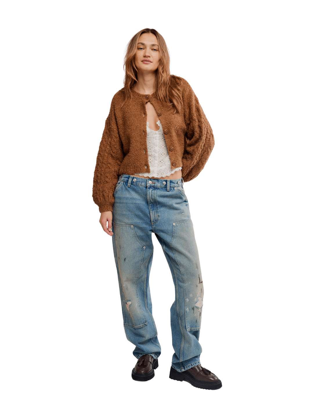 A model stands wearing a brown fuzzy cropped Thistle Cardi in Macadamia from Free People over a white top, light-wash distressed blue jeans, and dark brown leather shoes | Twentyseven Toronto
