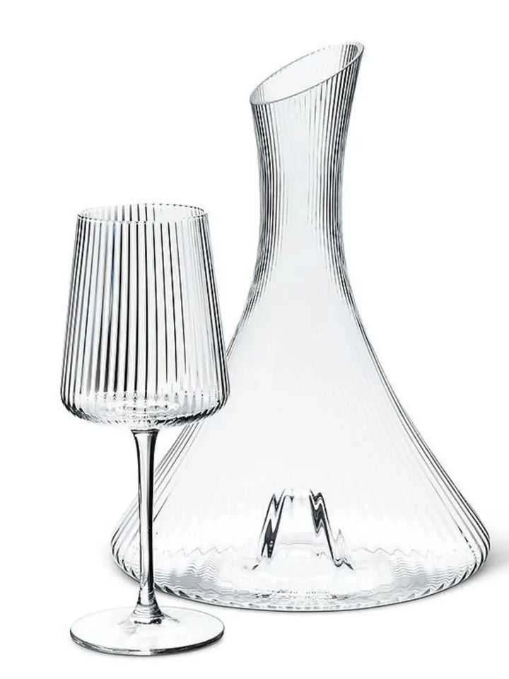 An empty, ribbed clear glass Abbott Collection Tight Optic Wine Glass is displayed next to a matching large wine decanter against a plain white background | Twentyseven Toronot