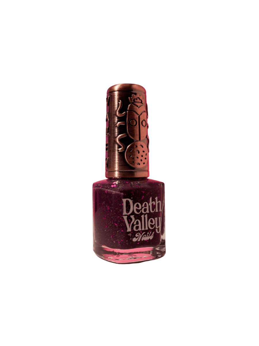 Purple bottle of 'Till Death Do Us Part' nail polish by Death Valley Nails with decorative cap on a transparent background | Twentyseven Toronto