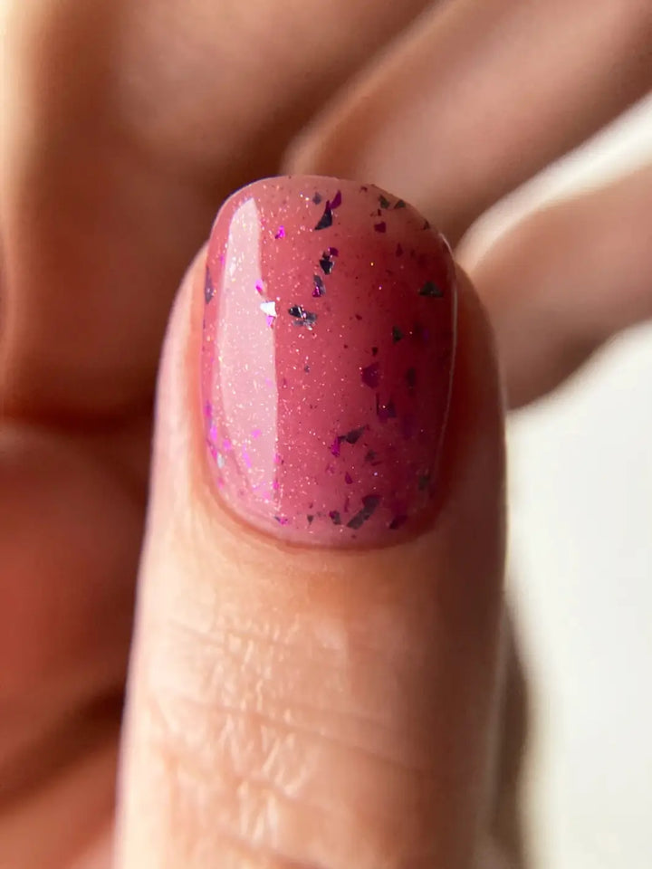 Close up of glittery pink nails using 'Till Death Do Us Part' nail polish by Death Valley Nails on a white background | Twentyseven Toronto