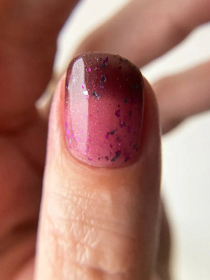 Close up of gradient glittery pink and purple nails using 'Till Death Do Us Part' nail polish by Death Valley Nails on a white background | Twentyseven Toronto